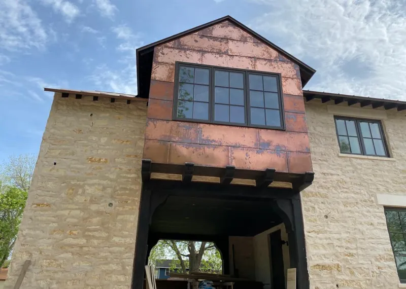Copper metal panel facade on a stone building for Skylight Installation in Pueblo West